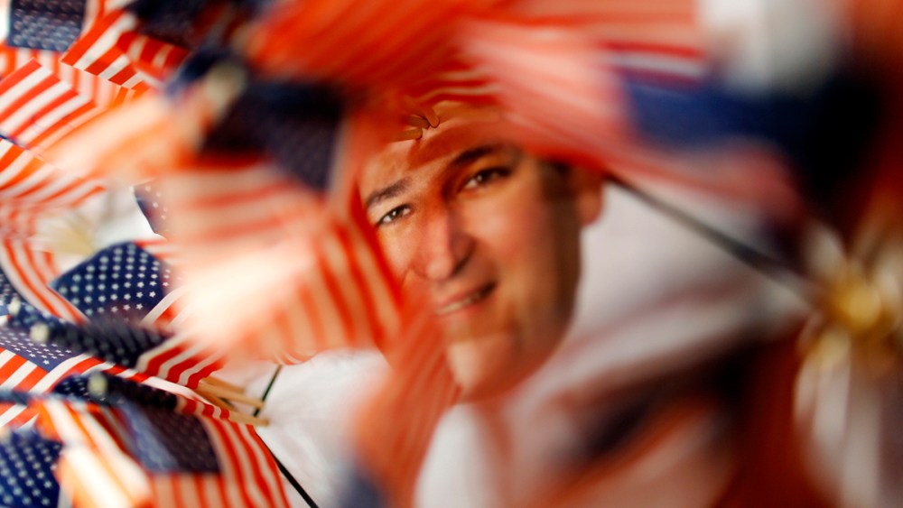 A picture of U.S. Senator Cruz is surrounded by small U.S. flags at a booth at the Conservative Political Action Conference in National Harbor, Maryland