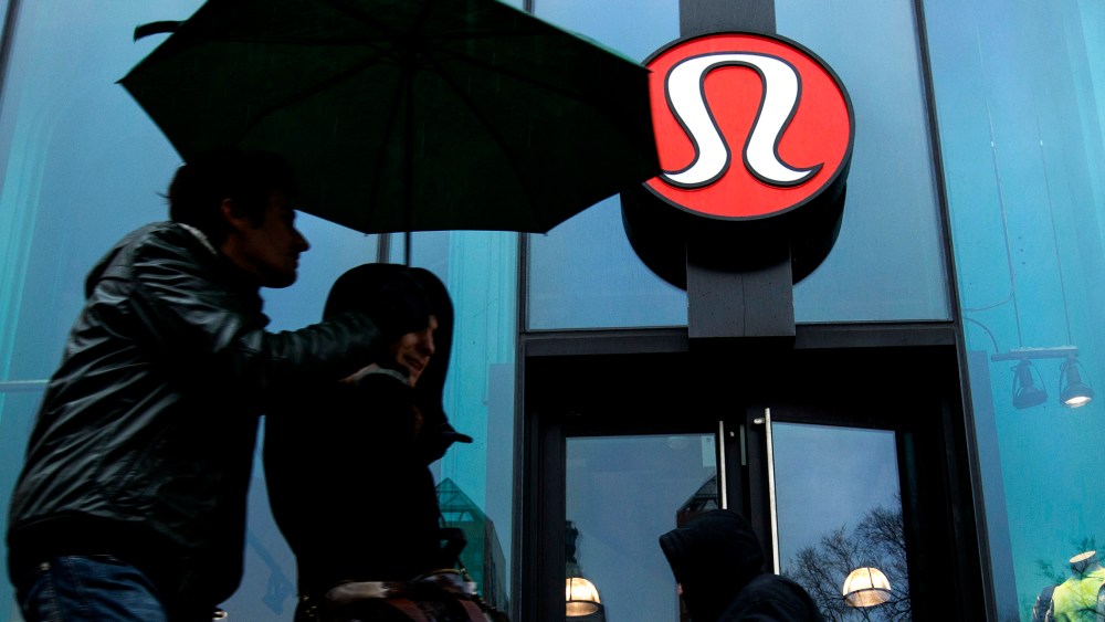 Pedestrians walk past a Lululemon Athletica store in New York