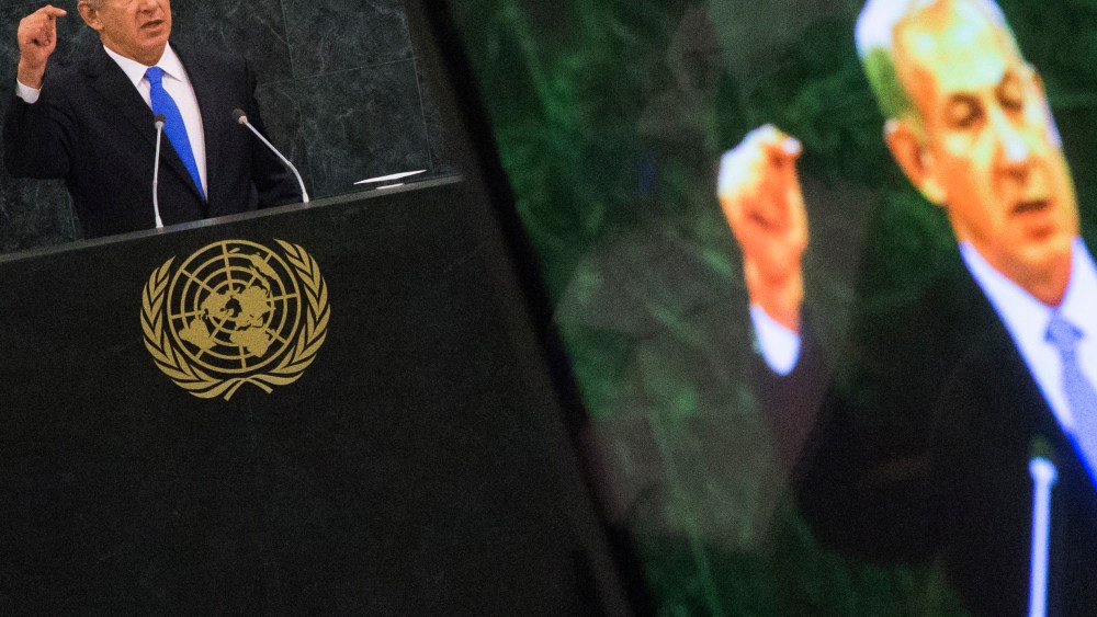Israel's PM Netanyahu is pictured on a television monitor while addressing the United Nations General Assembly in New York