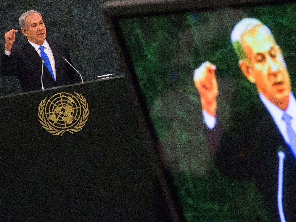 Israel's PM Netanyahu is pictured on a television monitor while addressing the United Nations General Assembly in New York