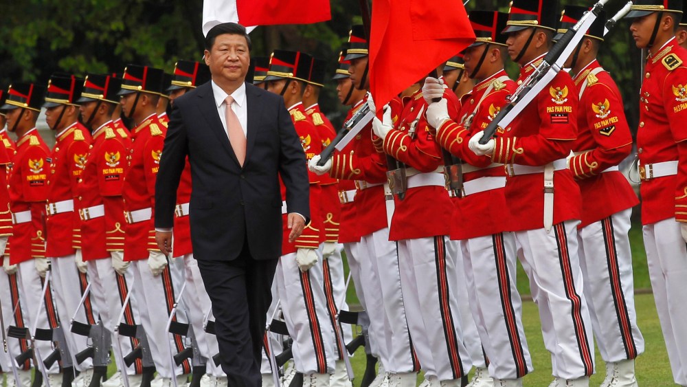 China's President Xi Jinping walks during a welcoming ceremony at the Presidential Palace in Jakarta October 2, 2013.