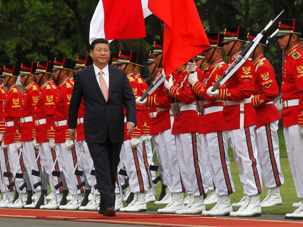 China's President Xi Jinping walks during a welcoming ceremony at the Presidential Palace in Jakarta October 2, 2013.