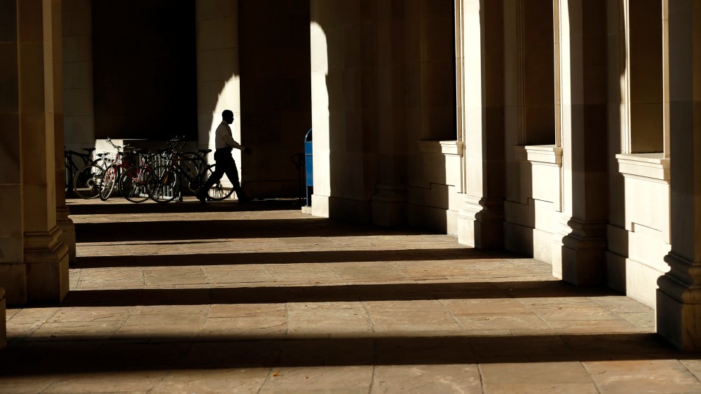 A lone worker enters Woodrow Wilson Plaza at Federal Triangle in Washington October 2, 2013.
