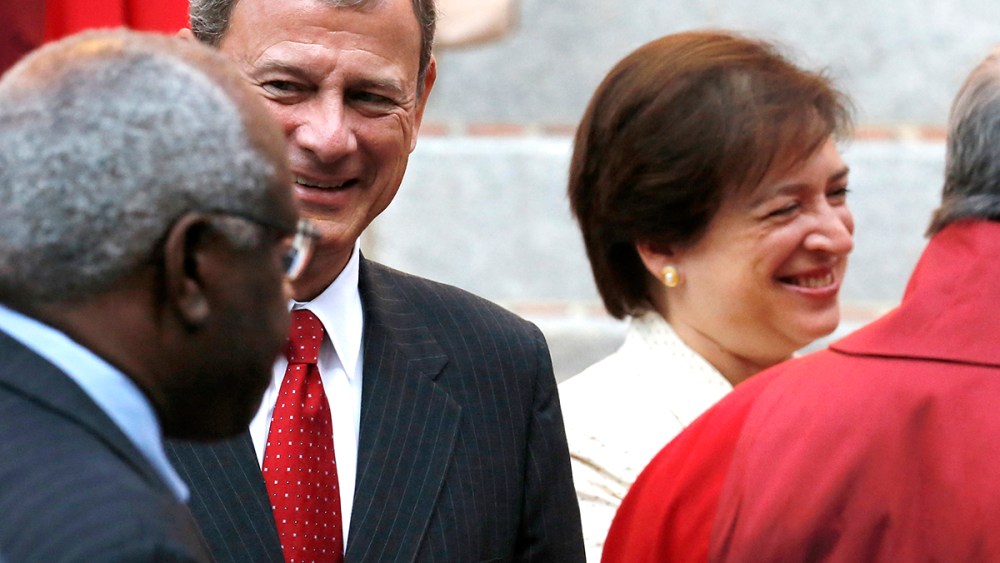 U.S. Supreme Court Justice Clarence Thomas (back to camera), Chief Justice John Roberts and Justice Elena Kagan
