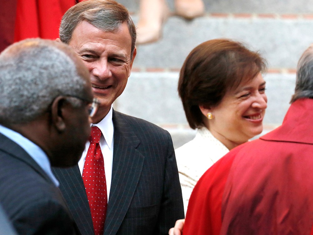 U.S. Supreme Court Justice Clarence Thomas (back to camera), Chief Justice John Roberts and Justice Elena Kagan