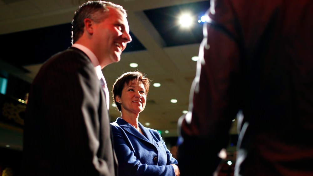 Republican David Jolly and Democrat Alex Sink,  candidates for Florida's congressional District 13, chat on stage during a break as they participate in a candidate forum in Clearwater, Florida, February 25, 2014.