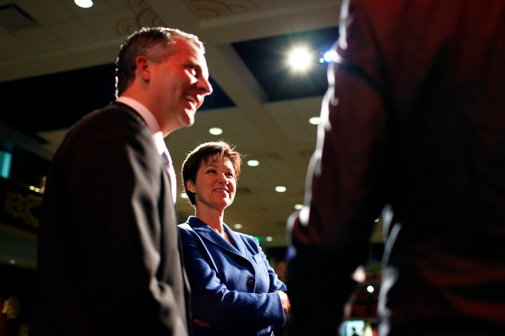 Republican David Jolly and Democrat Alex Sink,  candidates for Florida's congressional District 13, chat on stage during a break as they participate in a candidate forum in Clearwater, Florida, February 25, 2014.
