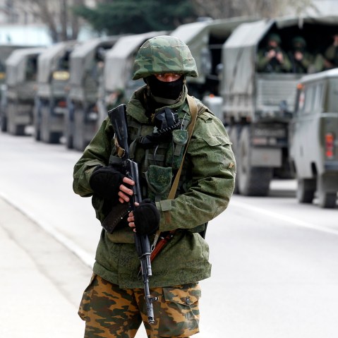 Armed servicemen wait in Russian army vehicles outside a Ukrainian border guard post in the Crimean town of Balaclava, March 1, 2014.