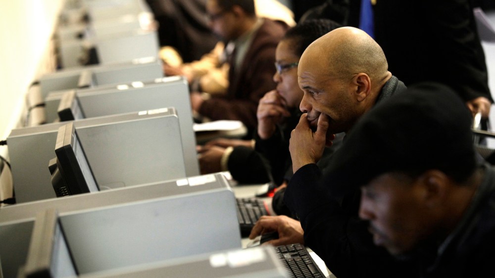 People use computers at a job fair in Detroit, Mich. on March 1, 2014.
