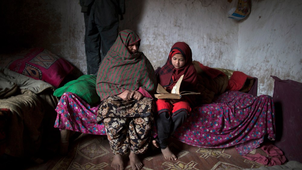 Tadjroshan, 40, poses for a photograph with her daughter Ayman, 12, at their house in a slum on the outskirts of Islamabad February 4, 2014. (Photo by Zohra Bensemra/Reuters)