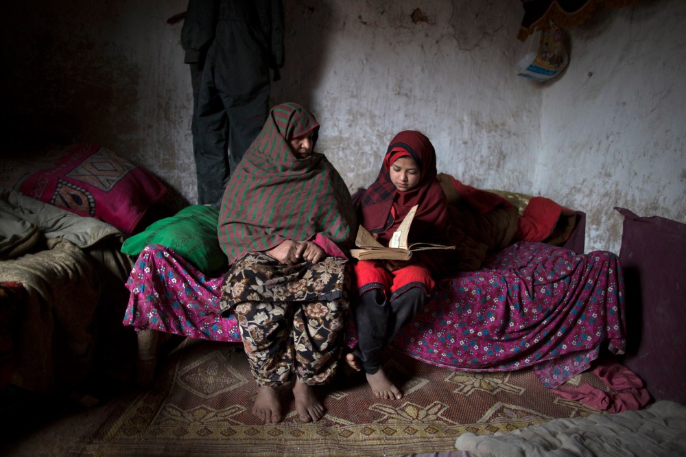 Tadjroshan, 40, poses for a photograph with her daughter Ayman, 12, at their house in a slum on the outskirts of Islamabad February 4, 2014. (Photo by Zohra Bensemra/Reuters)