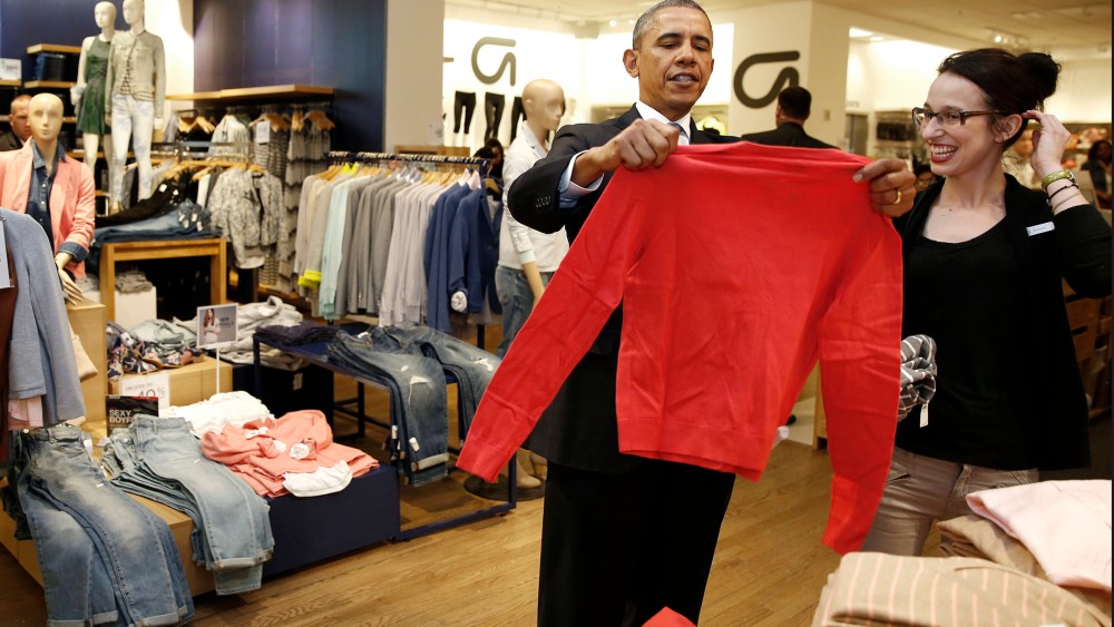 President Barack Obama looks for gifts for his family with salesperson Susan Panariello after stopping off at a GAP store in New York on March 11, 2014.