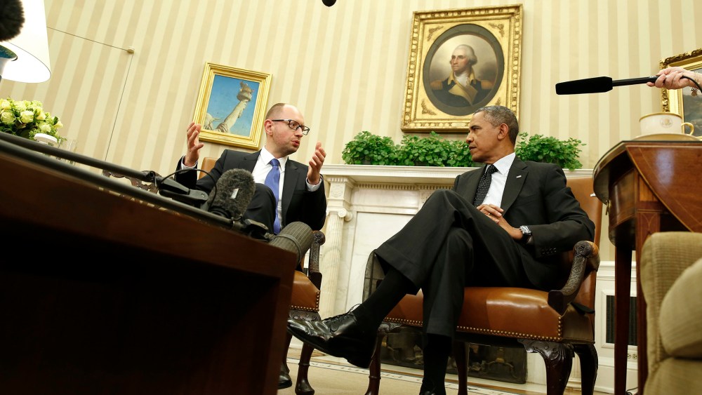 U.S. President Barack Obama listens as he hosts a meeting with Ukraine Prime Minister Arseniy Yatsenyuk (L) in the Oval Office of the White House in Washington on March 12, 2014.