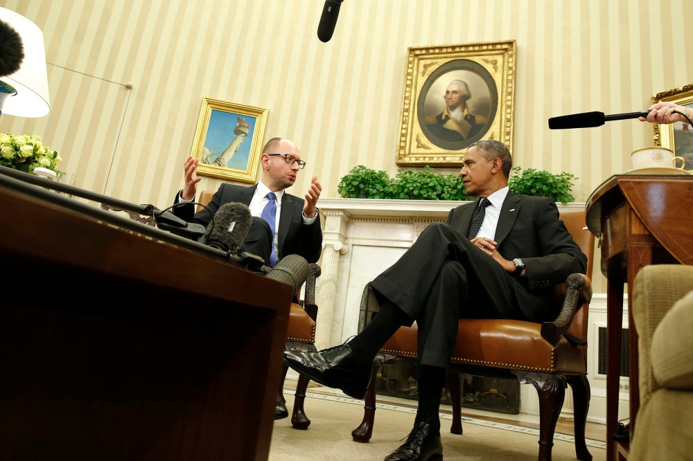 U.S. President Barack Obama listens as he hosts a meeting with Ukraine Prime Minister Arseniy Yatsenyuk (L) in the Oval Office of the White House in Washington on March 12, 2014.