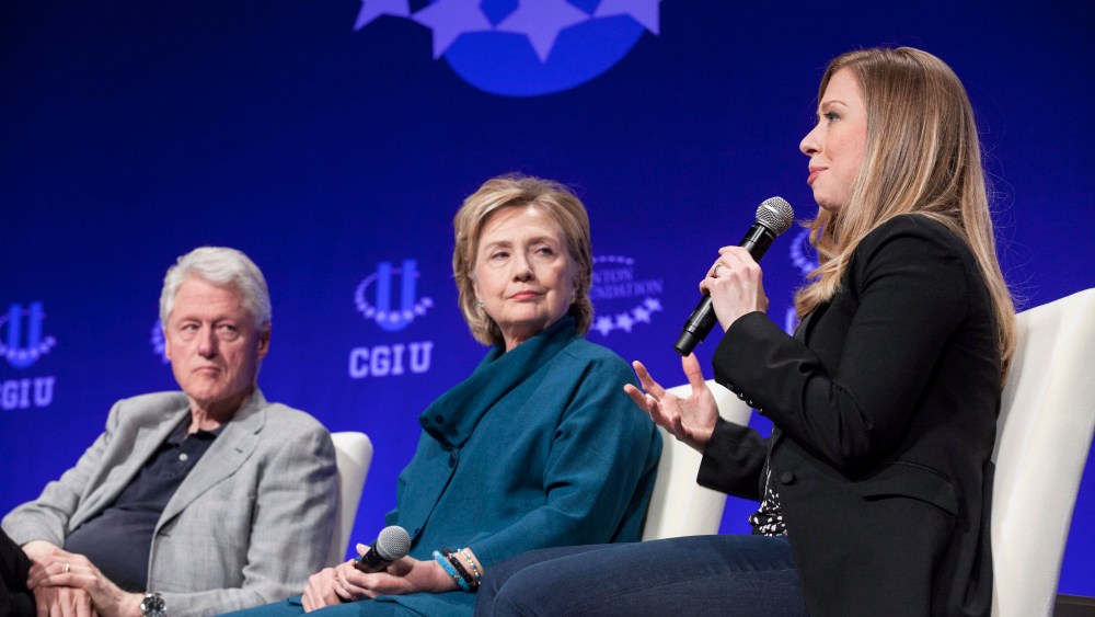 Former President Bill Clinton and former Secretary of State Hillary Clinton listen to their daughter and Vice Chair of the Clinton Foundation Chelsea Clinton in Tempe, Arizona on March 22, 2014. (Photo by Samantha Sais/Reuters)