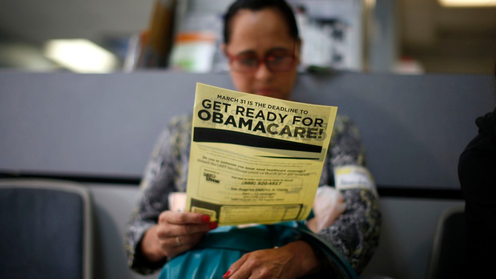Arminda Murillo, 54, reads a leaflet at a health insurance enrollment event in Cudahy, Calif., March 27, 2014.