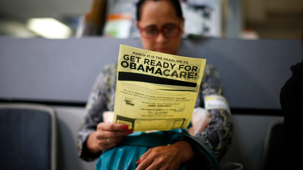 Arminda Murillo, 54, reads a leaflet at a health insurance enrollment event in Cudahy, Calif., March 27, 2014. (Photo by Lucy Nicholson/Reuters)