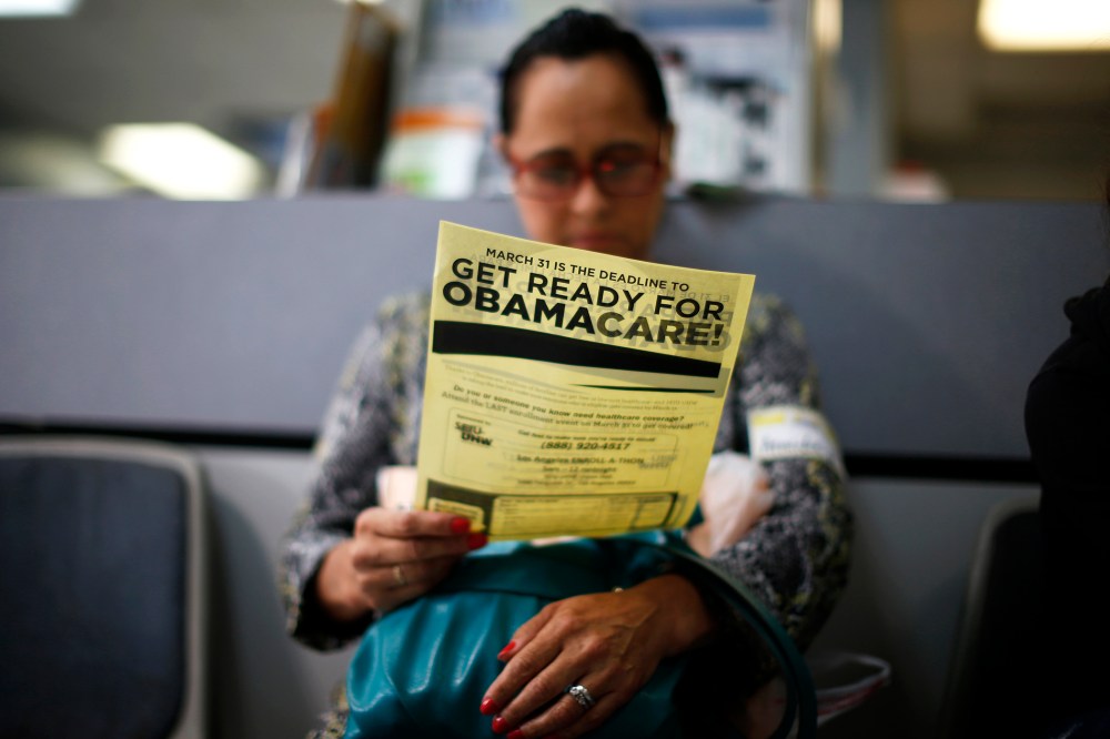Arminda Murillo, 54, reads a leaflet at a health insurance enrollment event in Cudahy, Calif., March 27, 2014. (Photo by Lucy Nicholson/Reuters)
