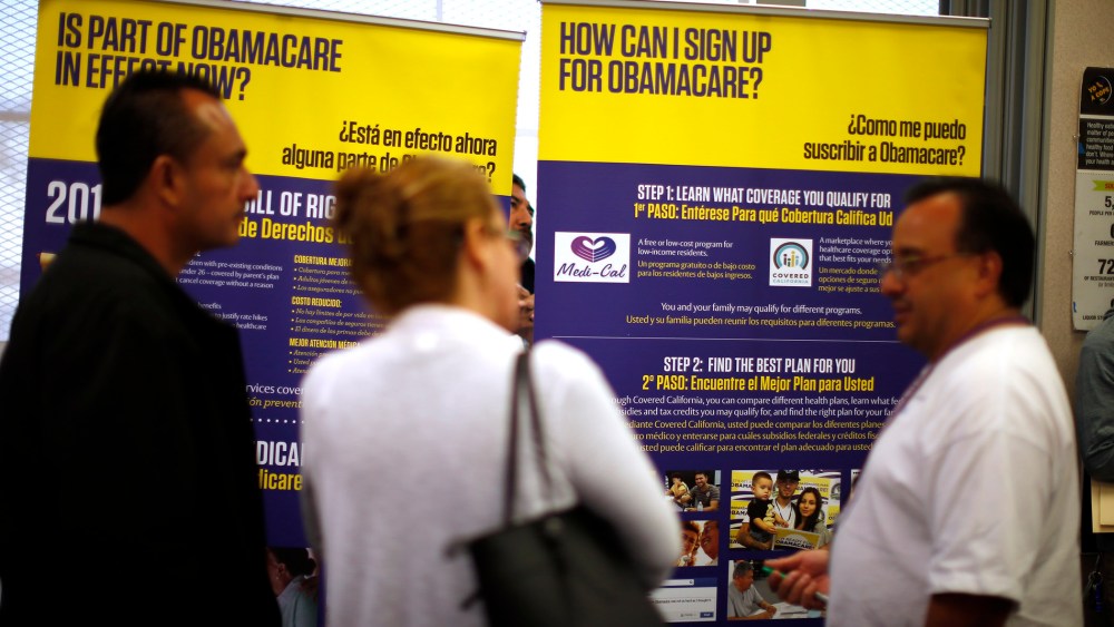 Julian Gomez explains Obamacare to people at a health insurance enrolment event in Commerce