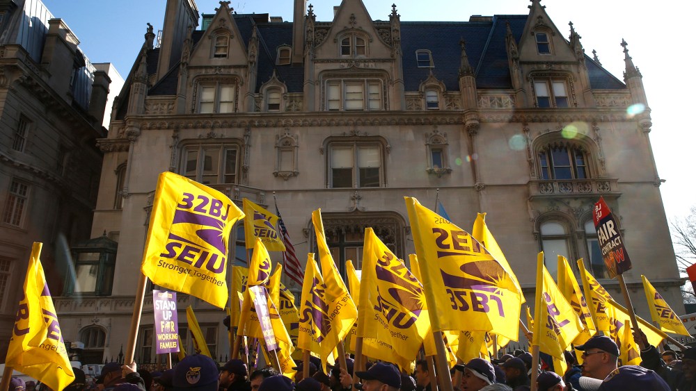 Members of the Service Employees International Union (SEIU) march during a protest in support of a new contract for apartment building workers in New York City, April 2, 2014