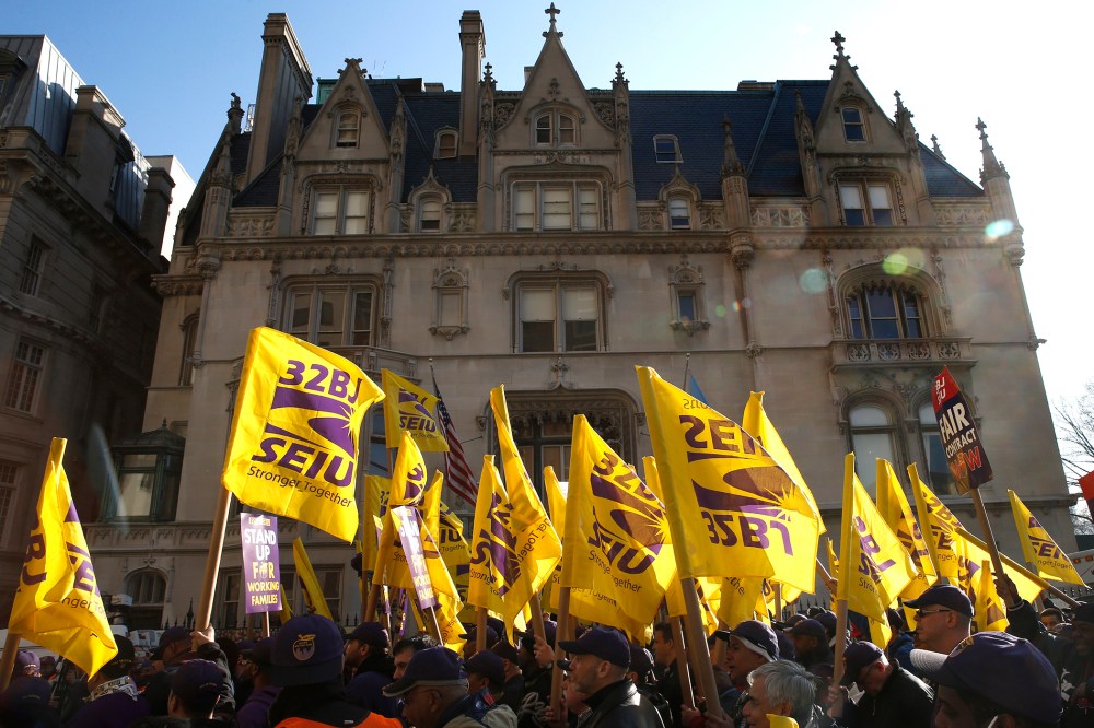 Members of the Service Employees International Union (SEIU) march during a protest in support of a new contract for apartment building workers in New York City, April 2, 2014
