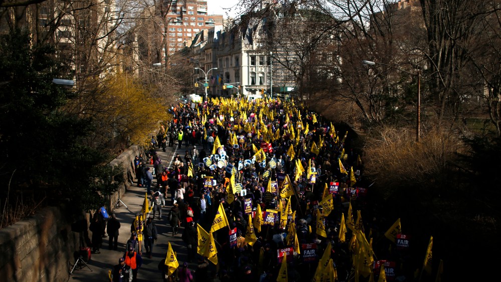Members of the Service Employees International Union (SEIU) march out of Central Park onto 5th Avenue during a protest in New York City.