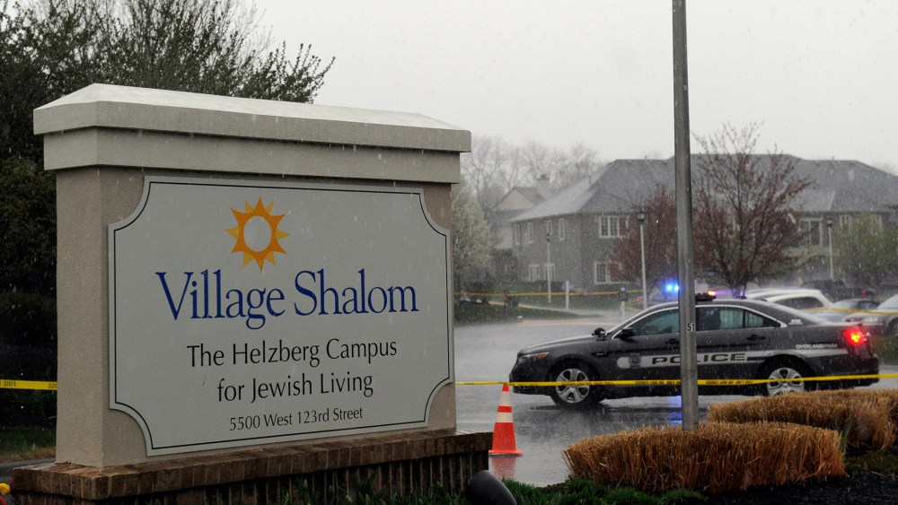 A police car blocks the scene of a shooting at Village Shalom, an assisted living center, as rain falls in Overland Park, Kansas April 13, 2014.