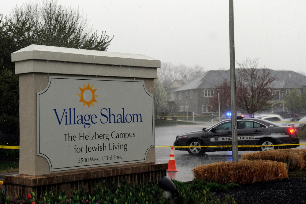 A police car blocks the scene of a shooting at Village Shalom, an assisted living center, as rain falls in Overland Park, Kansas April 13, 2014.