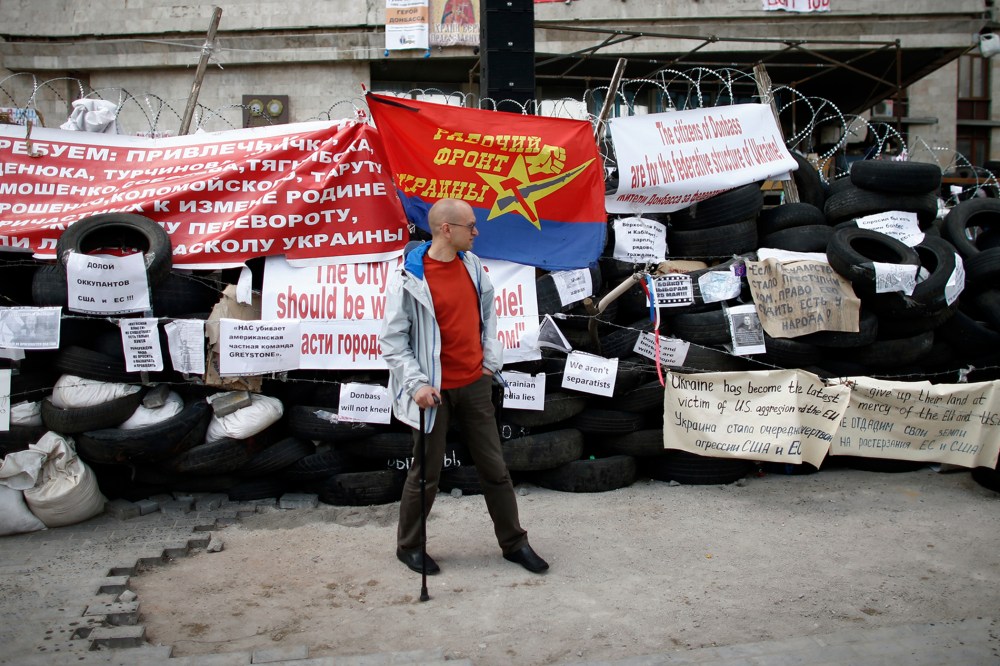 A pro-Russia protester stands at a barricade outside a regional government building in Donetsk