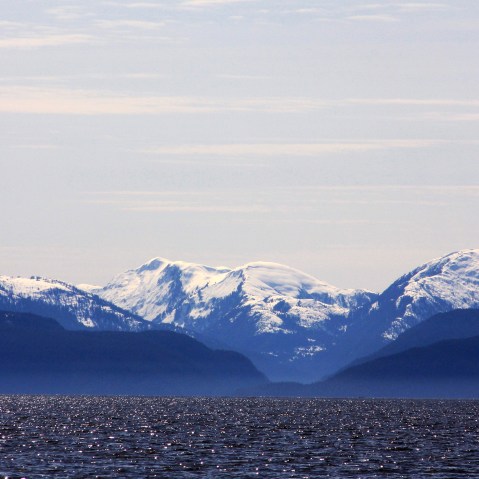 Snow-capped mountains peak out over a cove area favored by fishermen in the Douglas Channel, in northern British Columbia near to where Enbridge Inc plans to build its Northern Gateway pipeline terminal facility April 13, 2014.