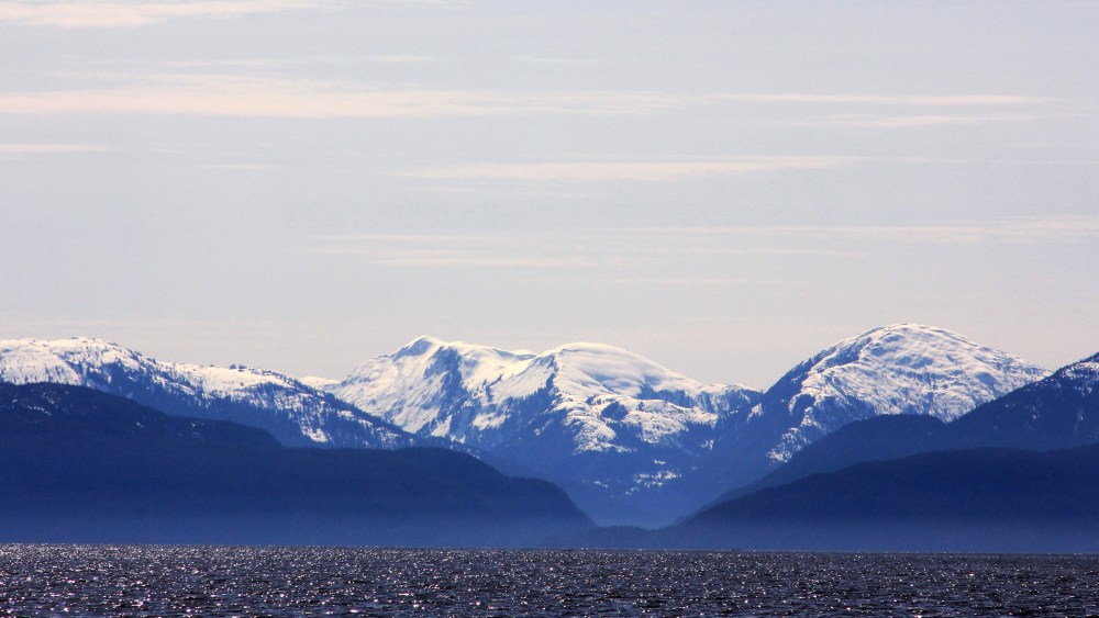 Snow-capped mountains peak out over a cove area favored by fishermen in the Douglas Channel, in northern British Columbia near to where Enbridge Inc plans to build its Northern Gateway pipeline terminal facility April 13, 2014.