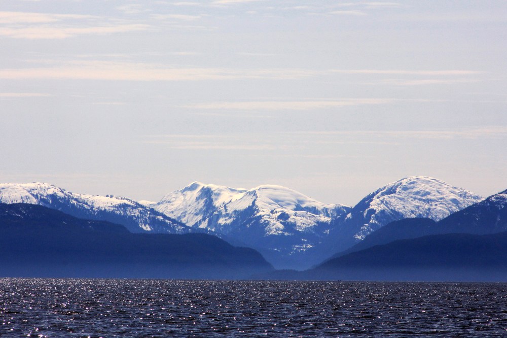 Snow-capped mountains peak out over a cove area favored by fishermen in the Douglas Channel, in northern British Columbia near to where Enbridge Inc plans to build its Northern Gateway pipeline terminal facility April 13, 2014.