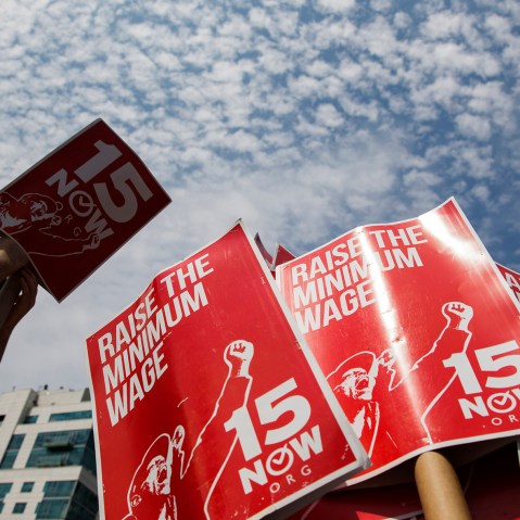 Demonstrators prepare signs supporting the raising of the federal minimum wage during May Day demonstrations in New York, N.Y., on May 1, 2014. (Photo by Lucas Jackson/Reuters)