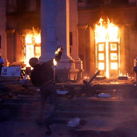 A protester throws a petrol bomb at the trade union building in Odessa May 2, 2014.