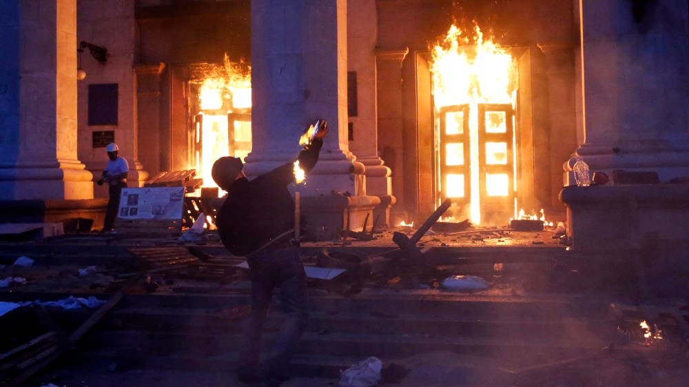 A protester throws a petrol bomb at the trade union building in Odessa May 2, 2014.
