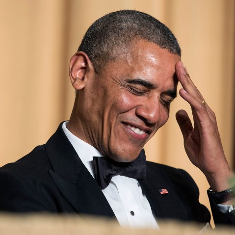 President Barack Obama rubs his head as he laughs at a joke during the White House Correspondents' Association Dinner in Washington May 3, 2014.