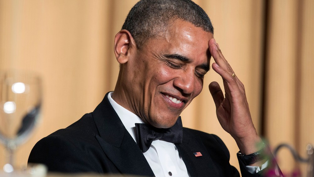 President Barack Obama rubs his head as he laughs at a joke during the White House Correspondents' Association Dinner in Washington May 3, 2014.