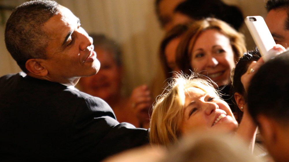 A woman makes a selfie as U.S. President Barack Obama greets guests at a Cinco de Mayo reception at the White House in Washington, May 5, 2014. (Photo by Yuri Gripas/Reuters)