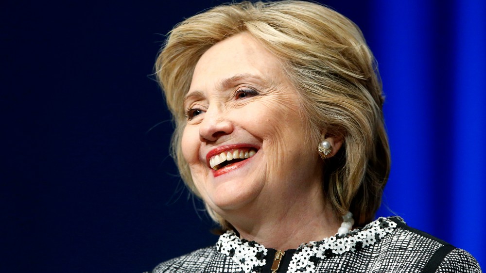 Former U.S. Clinton smiles during a lengthy ovation for her at the start of an event on empowering woman and girls, at the World Bank in Washington
