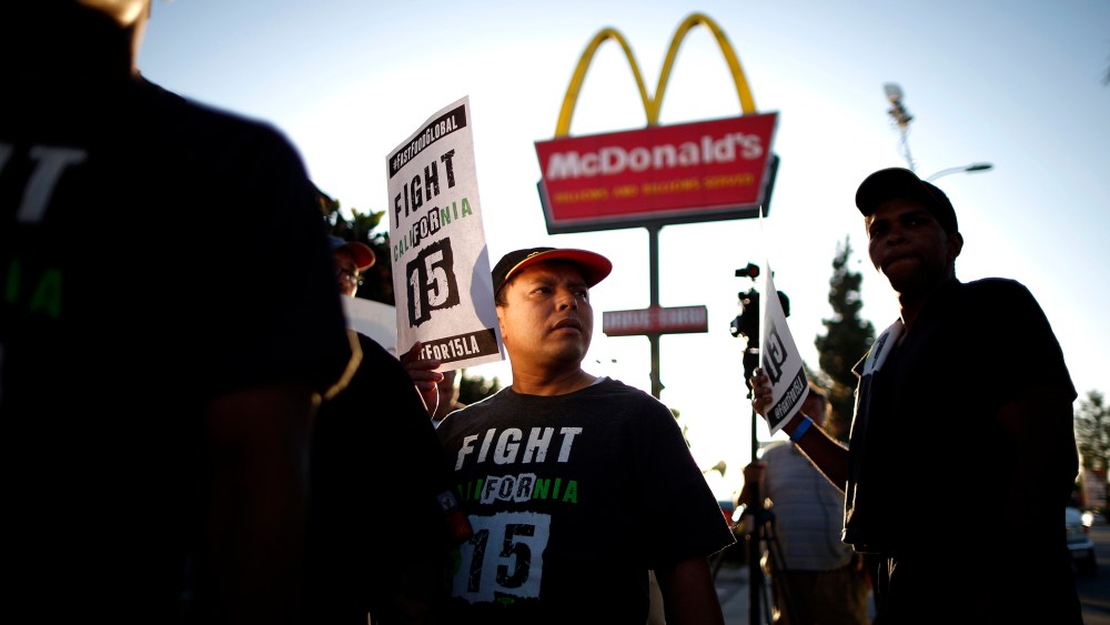 Demonstrators take part in a protest to demand higher wages for fast-food workers outside McDonald's in Los Angeles