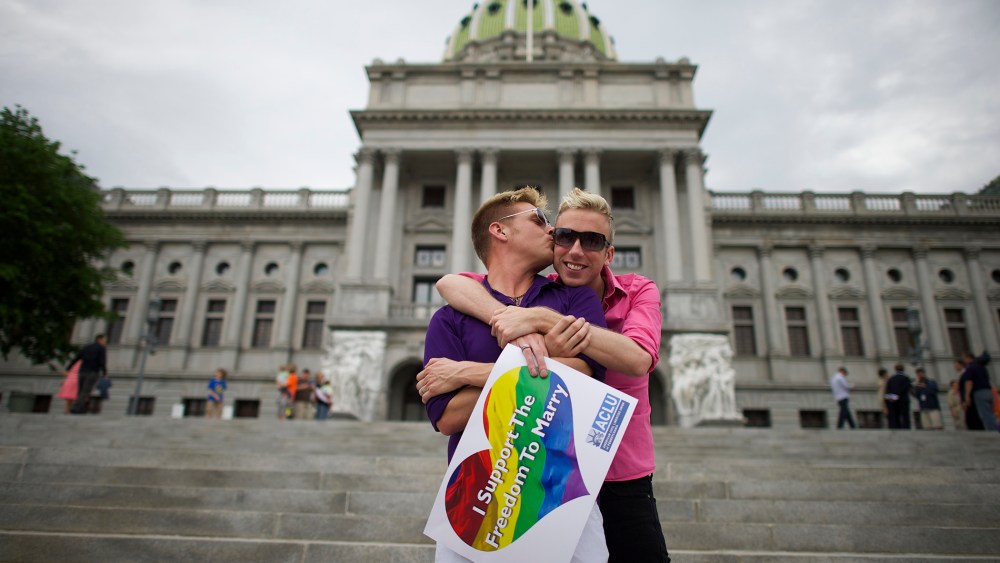 A couple embraces on the Pennsylvania State Capital steps following a rally with gay rights supporters in Harrisburg