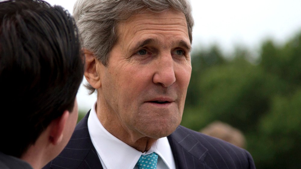U.S. Secretary of State John Kerry pauses on the tarmac before boarding his plane at Andrews Air Force Base