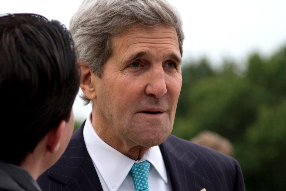 U.S. Secretary of State John Kerry pauses on the tarmac before boarding his plane at Andrews Air Force Base