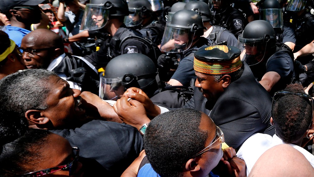 Demonstrators clash with police during a protest at the McDonald's headquarters in Oak Brook