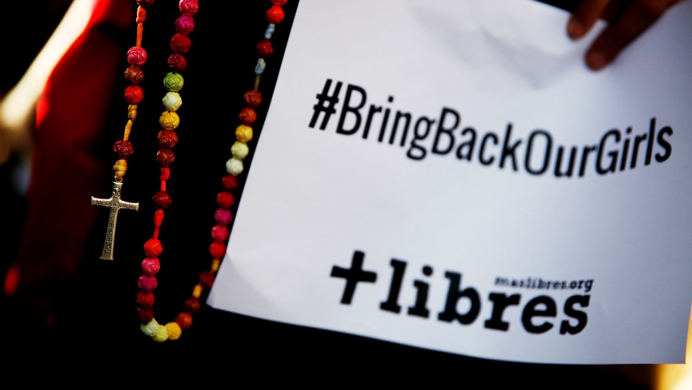 A poster with the Twitter campaign hashtag #BringBackOurGirls is seen during a prayer vigil showing support for Nigerian schoolgirls abducted by militant group Boko Haram, outside the Nigerian Embassy in Madrid May 22, 2014. (Photo by Susana Vera/Reuters)