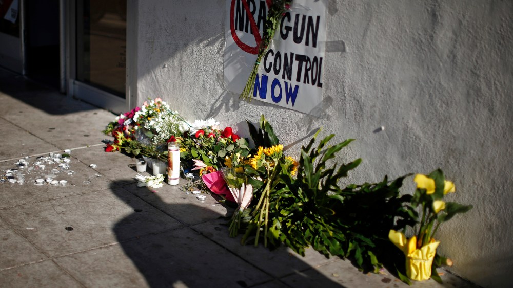 A sign advocating gun control is seen on a makeshift memorial for UCSB student Christopher Michael-Martinez in Isla Vista