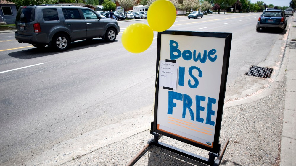 A car drives past yellow balloons and a sign of support for U.S. Army Sergeant Bergdahl in Hailey, Idaho