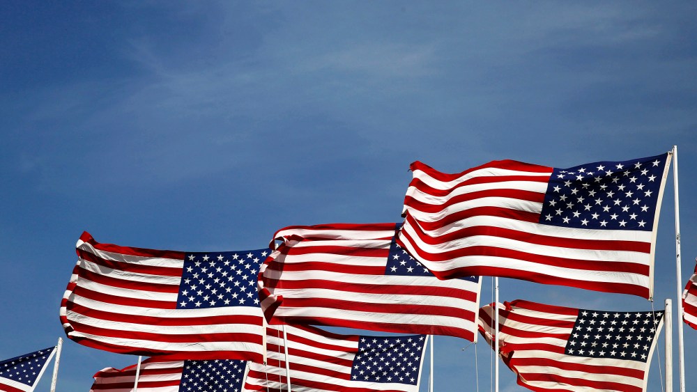 American flags flap in the wind. (Photo by Larry Downing/Reuters)