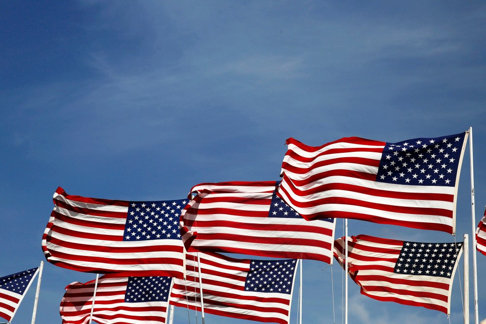 American flags flap in the wind. (Photo by Larry Downing/Reuters)