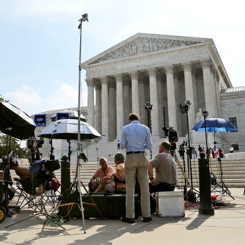 Numerous news crews await outside the Supreme Court in Washington June 25, 2014.